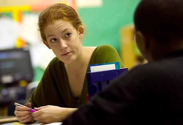 Sydney Ahearn, A.B. '08 and a Teach for America corps member, listens to a student's question in her classroom at James N. Thorp Elementary school.