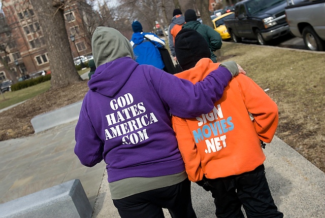 Shirley Phelps-Roper of Westboro Baptist Church, left, and her son Noah, right, walk back to their car after protesting with other members of her family on the University of Chicago campus.