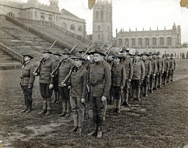 Students stand in military formation during training exercises held at Stagg Field in a World War 1 era photograph from the University Special Collections Research Center.
