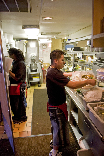Waiters must navigate efficiently in the small kitchen, which serves hundreds of customers a day.
