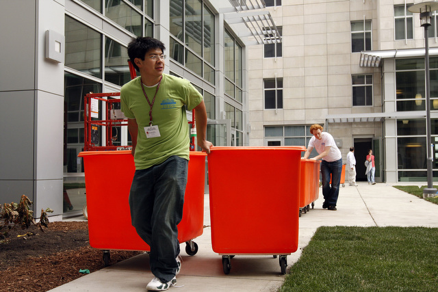 Second year Daniel Zhong assists in returning bins to the front of South Campus Residence Hall.