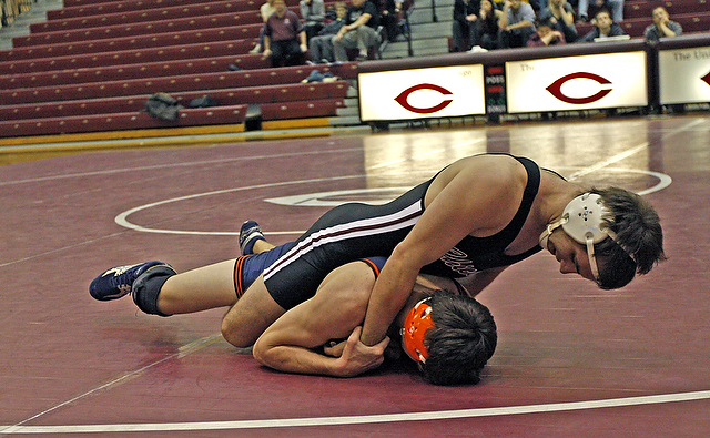 Third-year Chris Oster grapples Wheaton's Casey Krahn in Tuesday's match against Wheaton at Ratner Athletics Center.