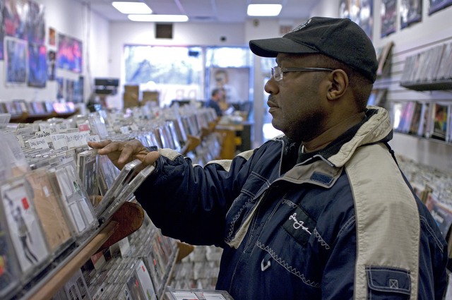 A Hyde Park resident browses among the CDs on display at Dr. Wax, which will close on February 15.