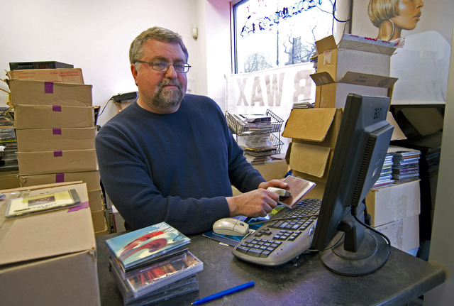 Dr. Wax owner Sam Greenberg inventories the store's remaining stock of CDs, which he plans to liquidate in a closing down sale beginning February 1.