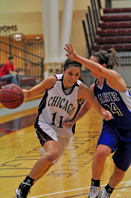 Second-year guard Meghan Herrick dribbles around a Case player during Sundays home game. The game ended in a 58-57 victory for the Maroons, with Herrick among the leading scorers.
