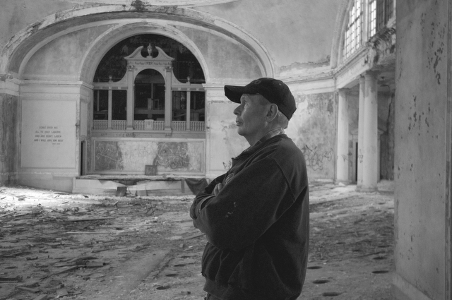 A contractor looks into the distance in the main sanctuary of St. Stephen's Church.