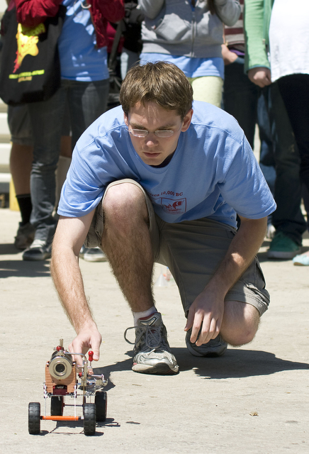 Fourth-year Nathaniel Berry attempts to start The Blintstones' steam-powered car at the Scav Hunt judging session at Ida Noyes Hall on Sunday. None of the teams' inventions managed to achieve steam-propelled motion. (Item #73)