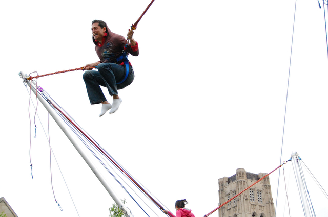 Fourth-year Igor Gartel soars above campus on the bungee trampoline at the Summer Breeze carnival on Saturday.