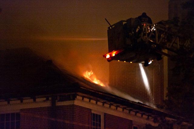 Firefighters battle scorching flames on the roof of the Math-Stat building Tuesday evening.