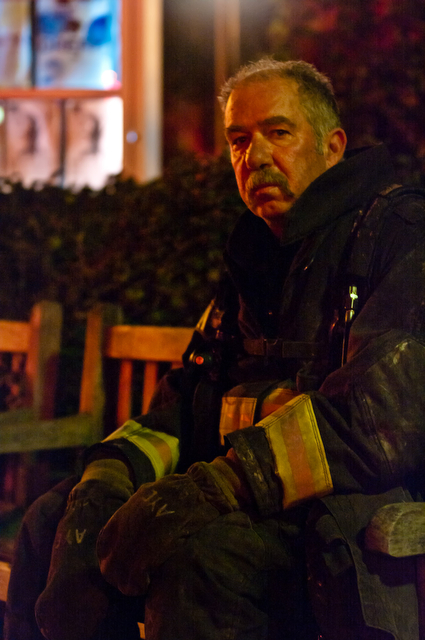 A exhausted firefighter rests outside the Reynolds Club after battling the blaze at the Math-Stat building.