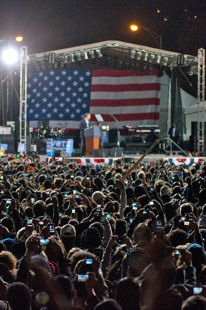 Members of the crowd at the Democrat rally raise their cellphones and cameras overhead to capture photographs of President Barack Obama as he finally arrives on stage.