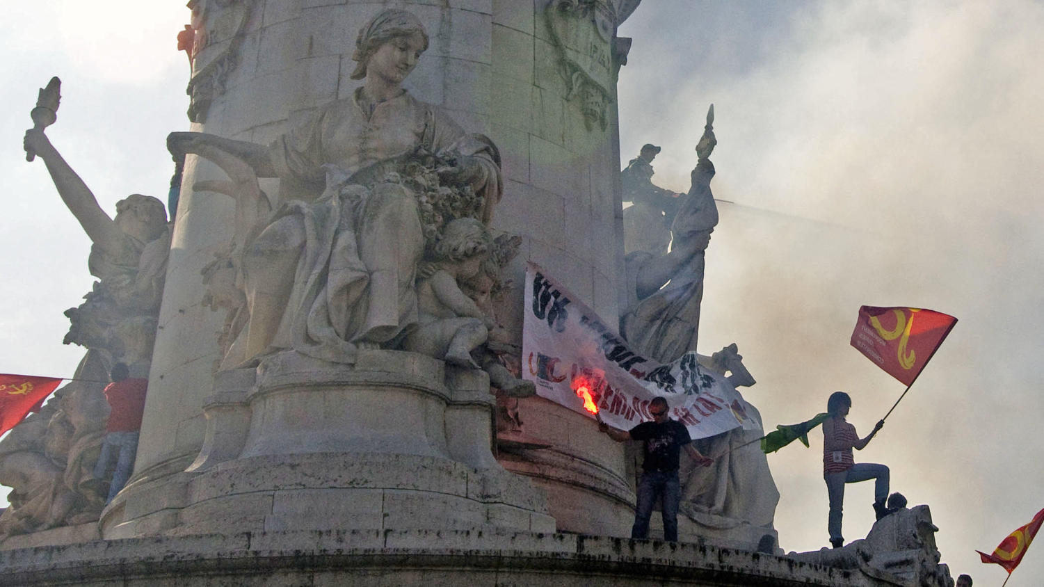 Protesters riot on the central statue at the Place de la Republique last Thursday, two days after the Senate passed the retirement bill.