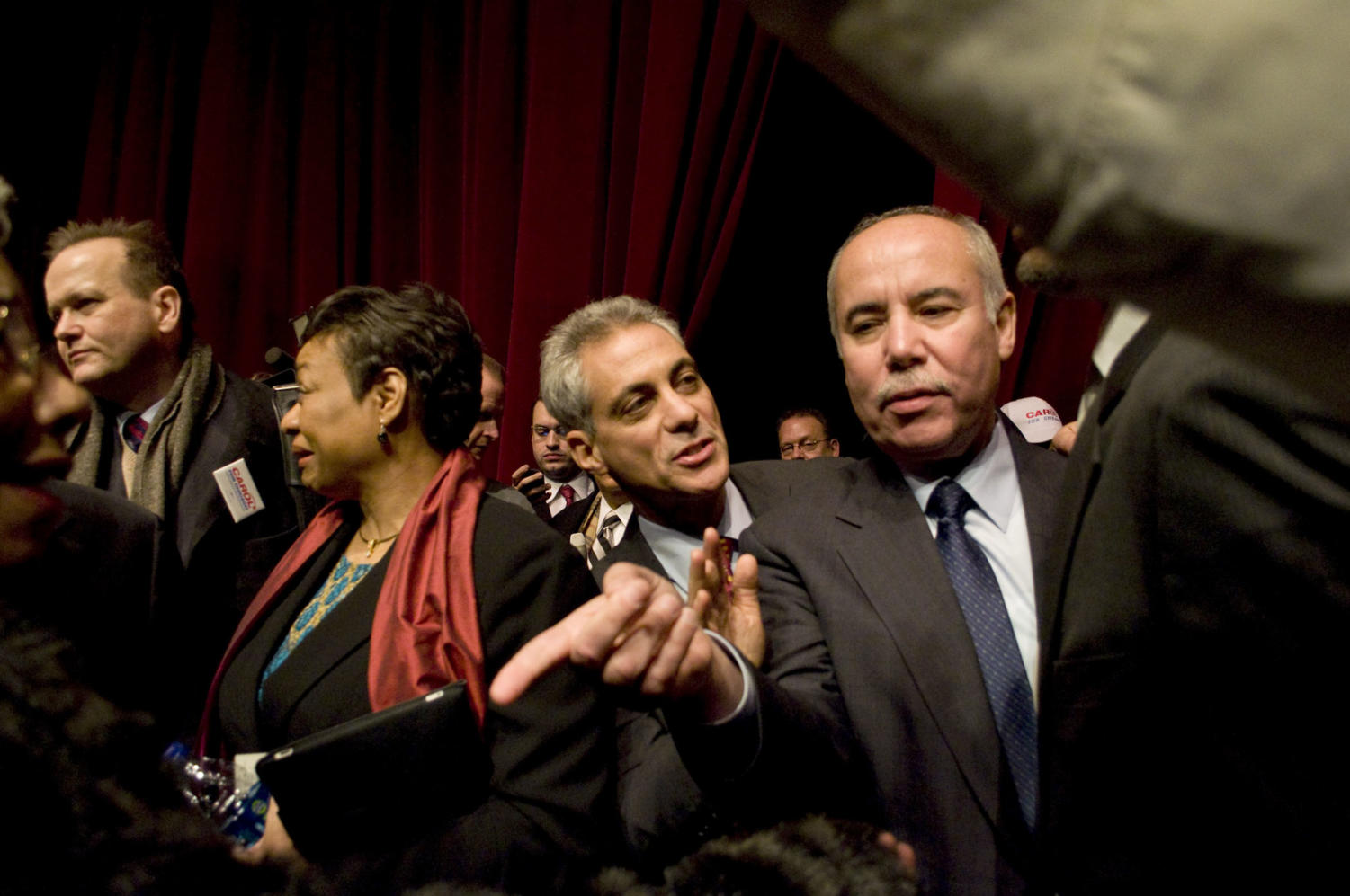 Rahm Emanuel and Del Valle make their way towards the front of the stage for a group photograph.
