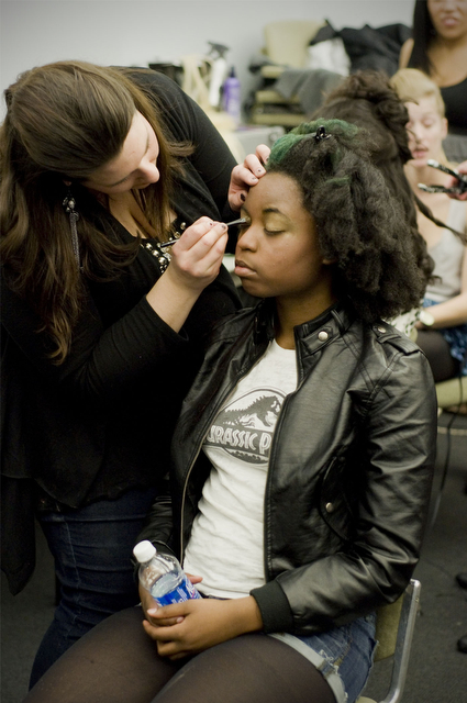 Fourth-year Milan Neeley has her makeup prepared by a Paul Mitchell artist  before the MODA Spring 2011 Fashion Show at the Chicago Cultural Center Friday night.