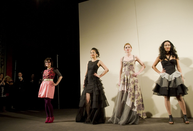 First-year Anita To (left), third-year Samantha Edds (middle), and second-year Ethel Yang (right) model designs Anastasia Chatzka (far left).