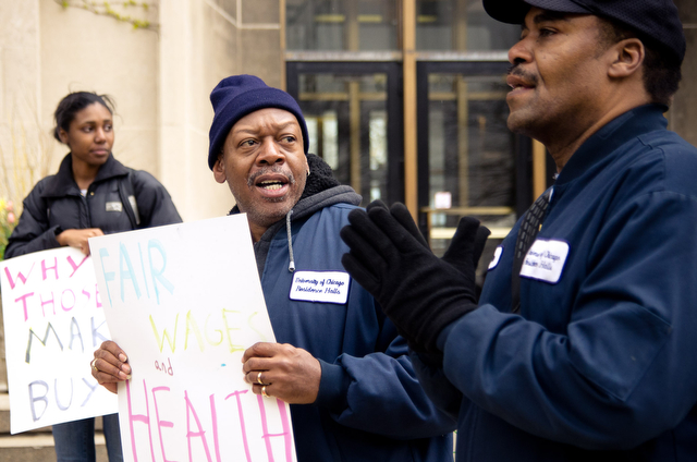 Tyrone Orange (middle), a housekeeping employee with the University for the past 15 years, joins students and fellow employees in a rally Thursday afternoon outside the Admin building.