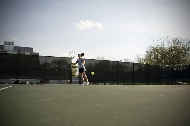 Third-year Kendra Higgins takes practice shots during the women's Tennis team's practice on Thursday.