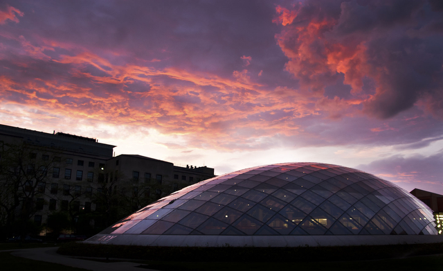 The sky lights up behind the newly-built Mansueto Library.