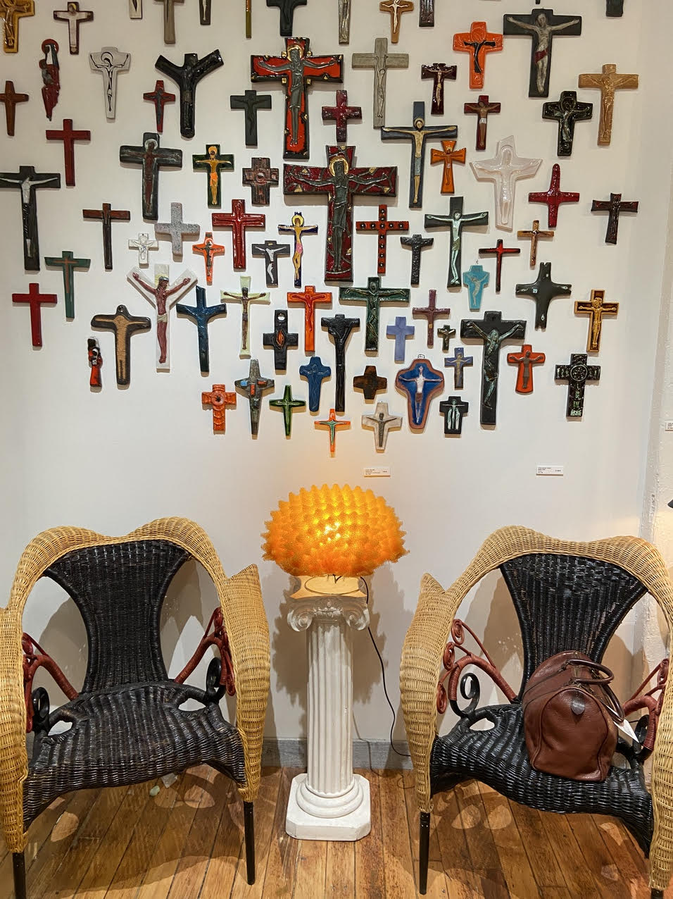 The small, intimate space was backdropped by mid-century ceramic wall crucifixes from Belgium.