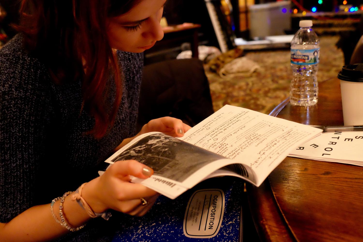 A student reads Eldred's zines.