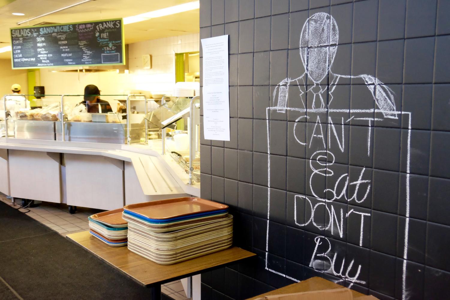 Akeem Haywood's chalk drawings don the walls as the artist works behind the counter.