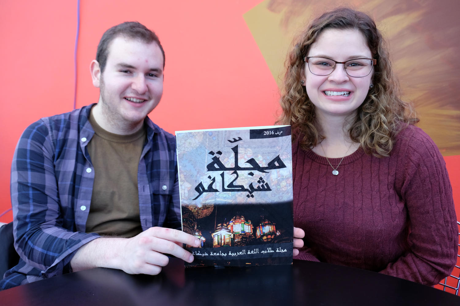 Managing Editor Madeline de Figueiredo and Leadership Team Member Gabe Davis pose with the inaugural issue of Majalla.