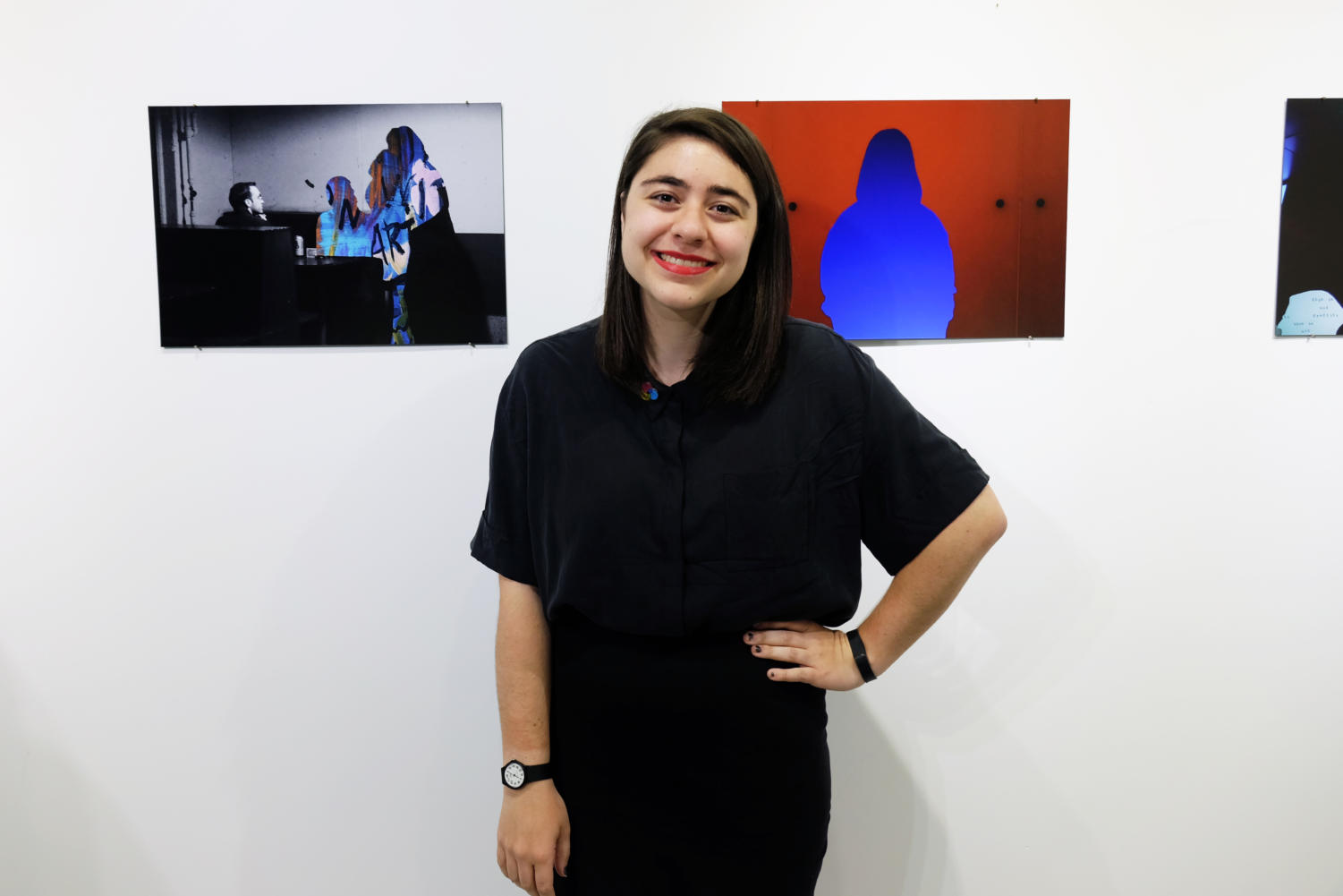 Fourth-year Juliet Eldred poses with her collages at 