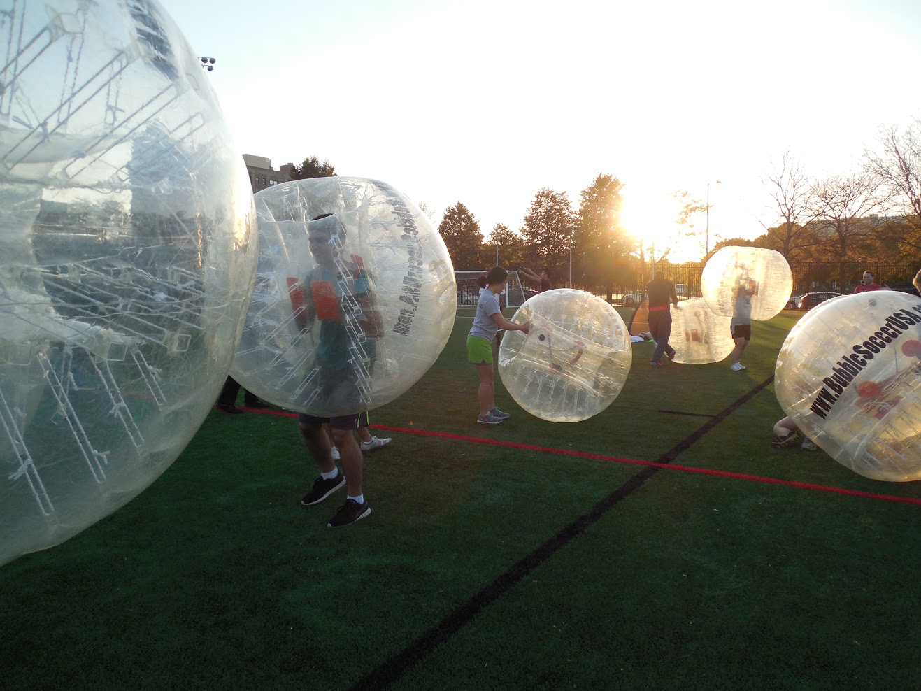 Bubble soccer players prepare to start a game. 