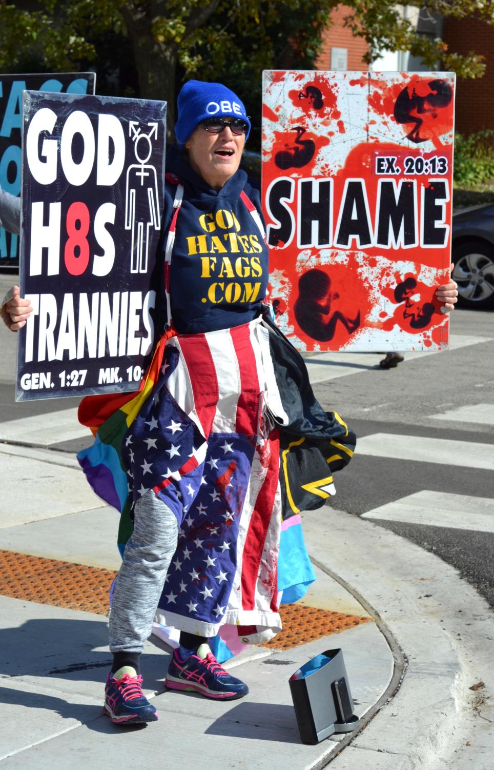 A picketer holds a sign reading 