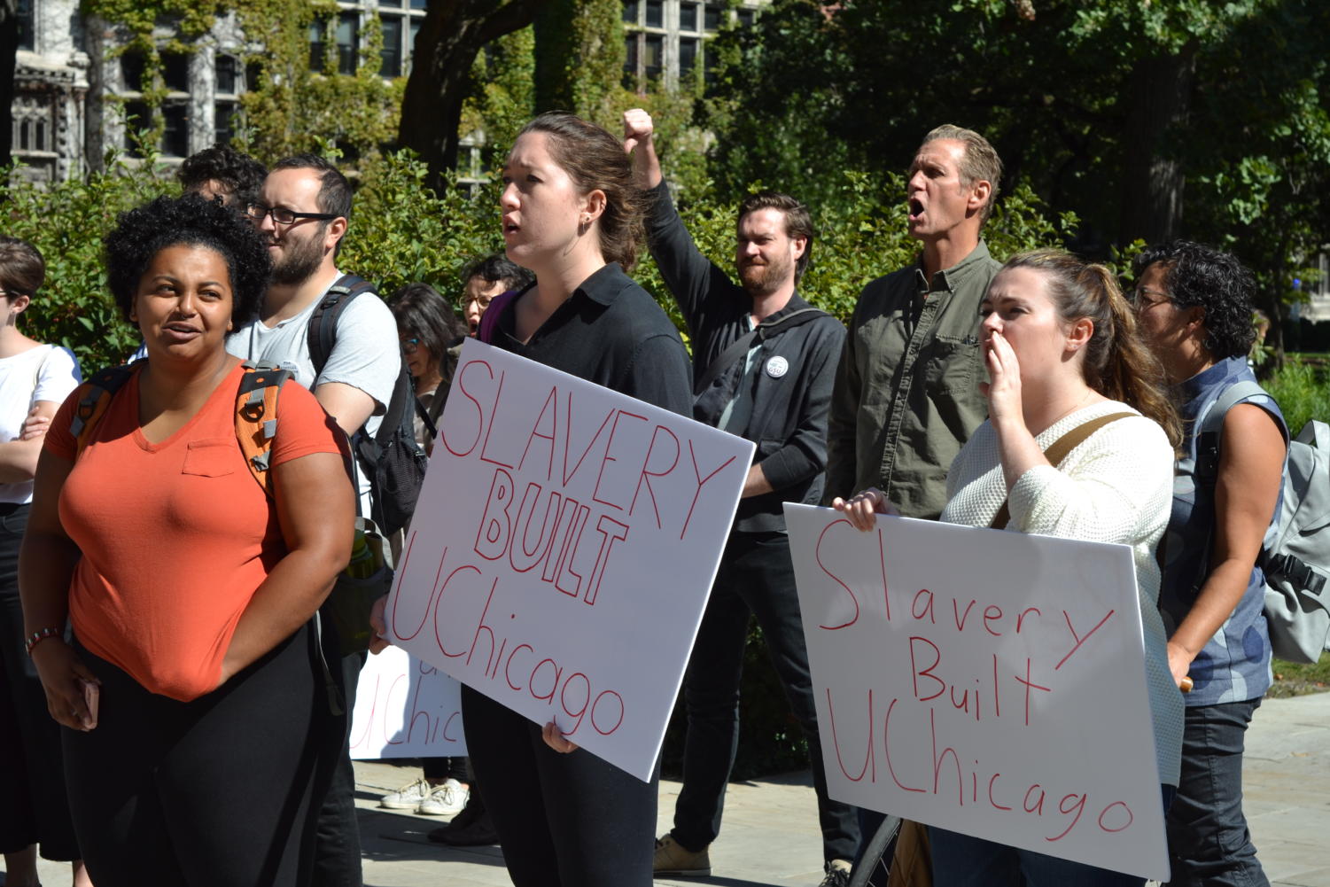 Students hold up protest signs at a racial justice rally last Friday.