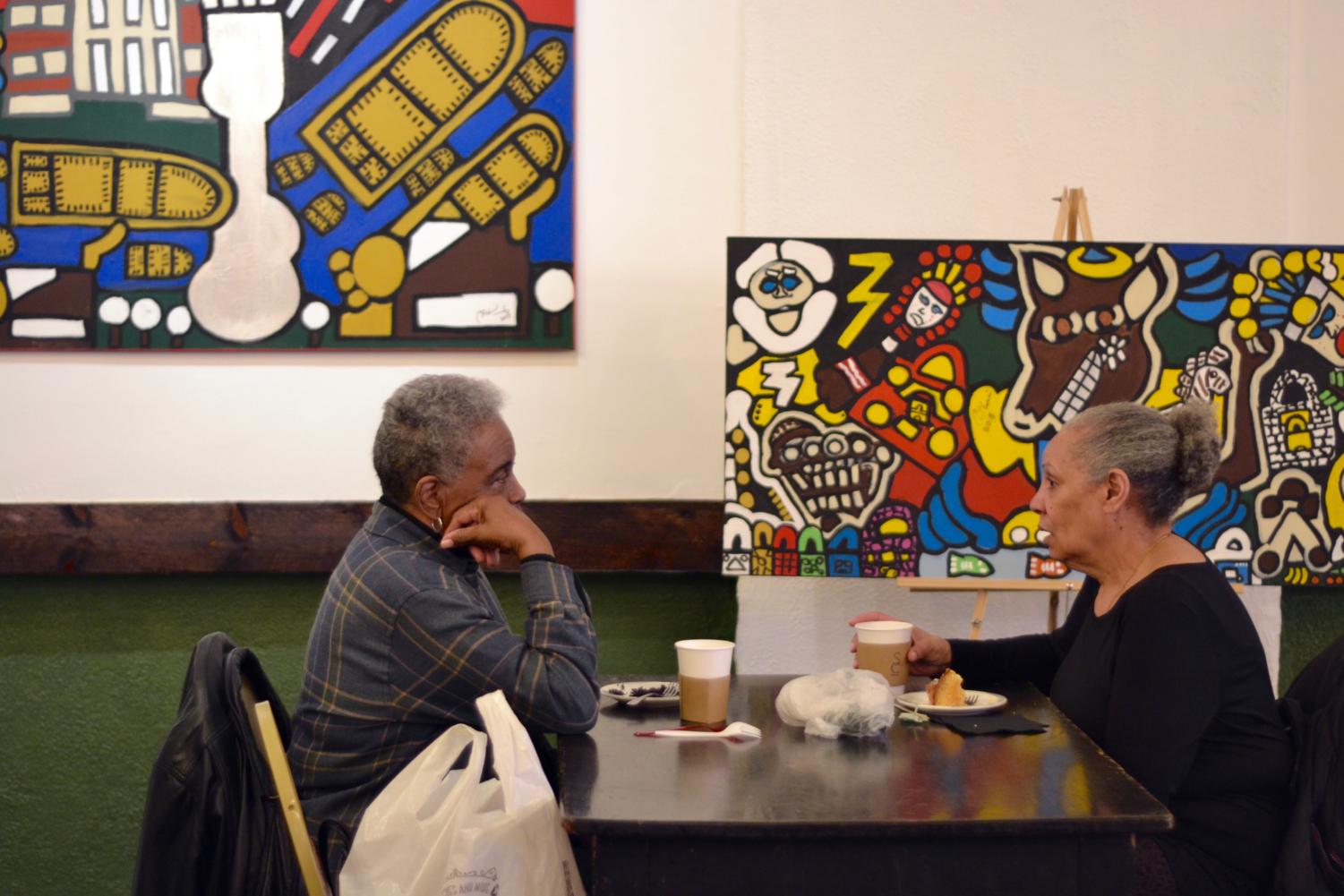 Hyde Park residents enjoy some coffee and pastries on Monday afternoon at the Grand Opening of Sanctuary Cafe in University Church.