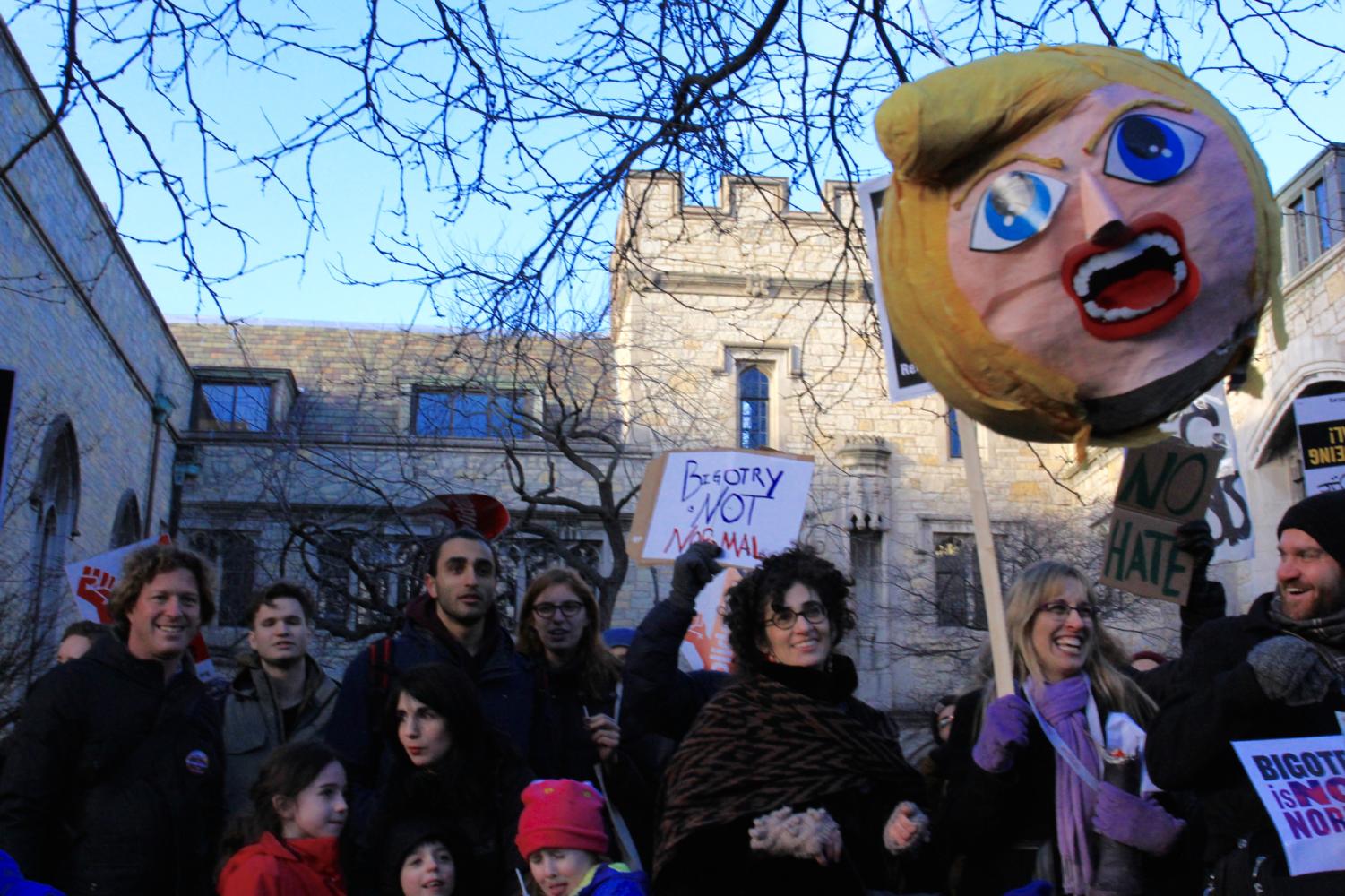 After kids broke a piñata that represented Donald Trump by hitting it with a long stick, the head of the piñata hung in front of the protesters.