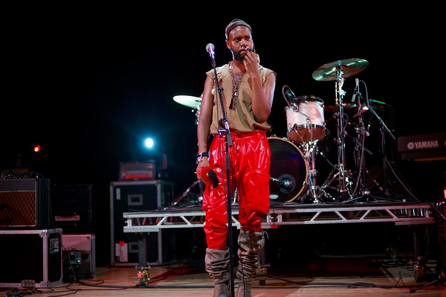 serpentwithfeet, decked out in red leather pants and heeled boots, addresses audience