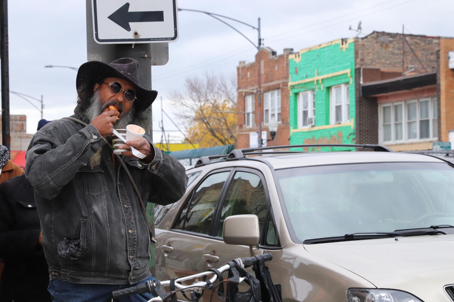 A passer-by enjoys the hot soup and garlic bread served at a 'Refresh the Hood' held by IMAN on October 22nd.