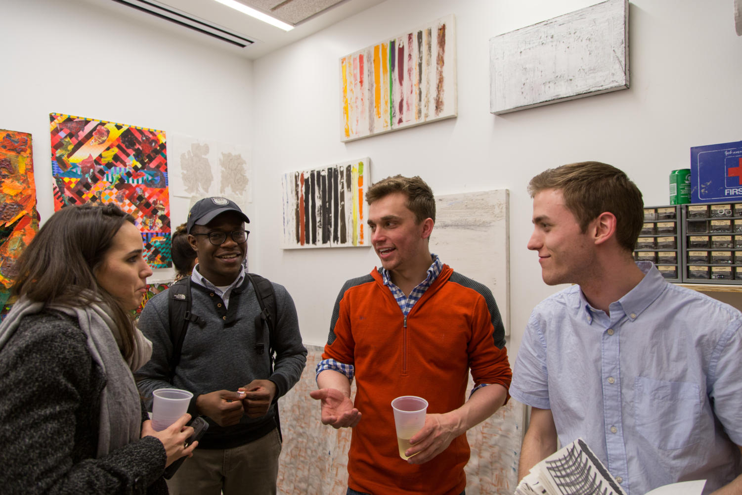 Chet Lubarsky (second from right) talks to Nerjada Maksutaj (left), Michael Harvey
(second from left), and Sean Clemmer (right) during the DoVA exhibit on Tuesday evening.