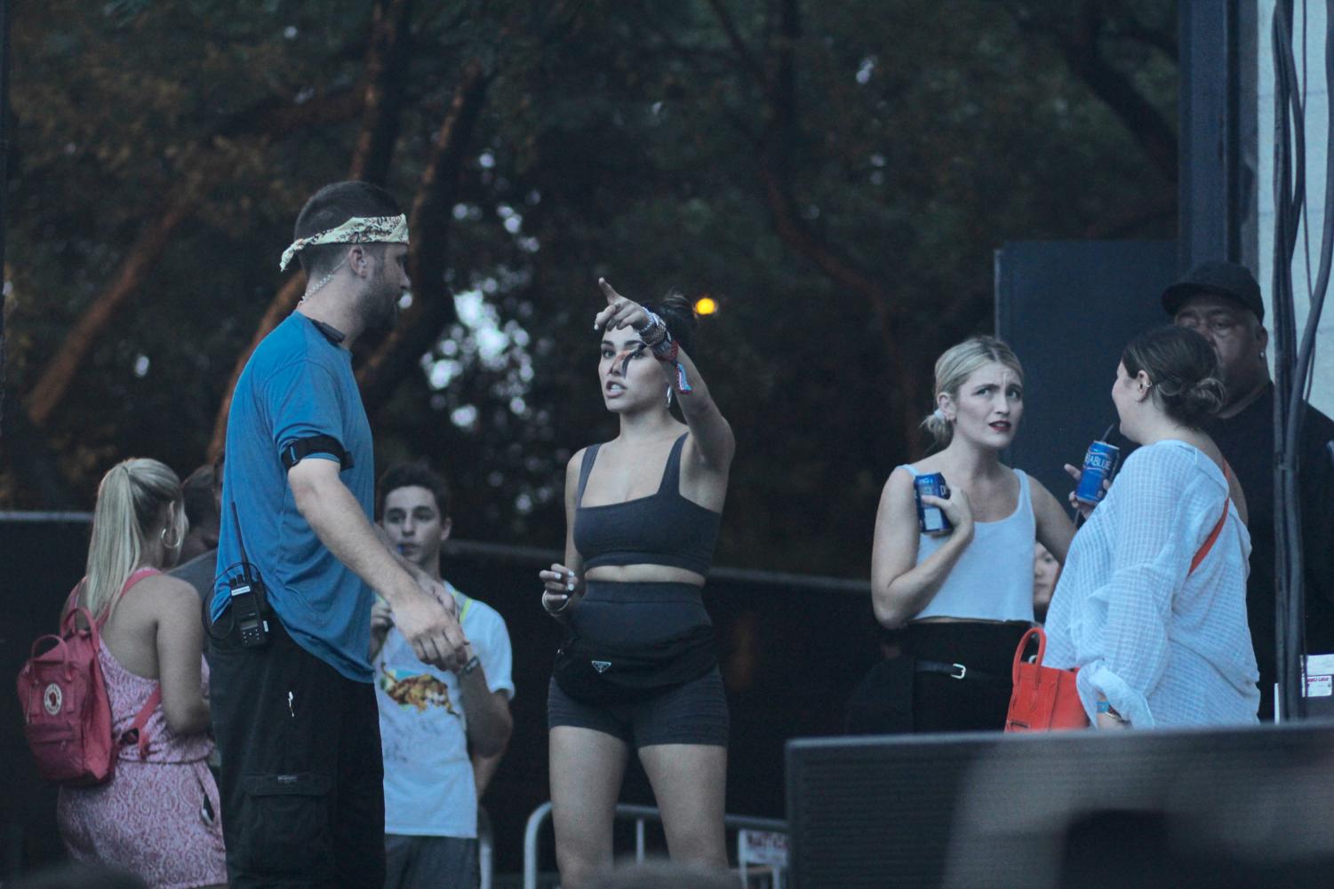 Madison Beer, who performed earlier in the festival, watches Medasin's set from the side of the stage