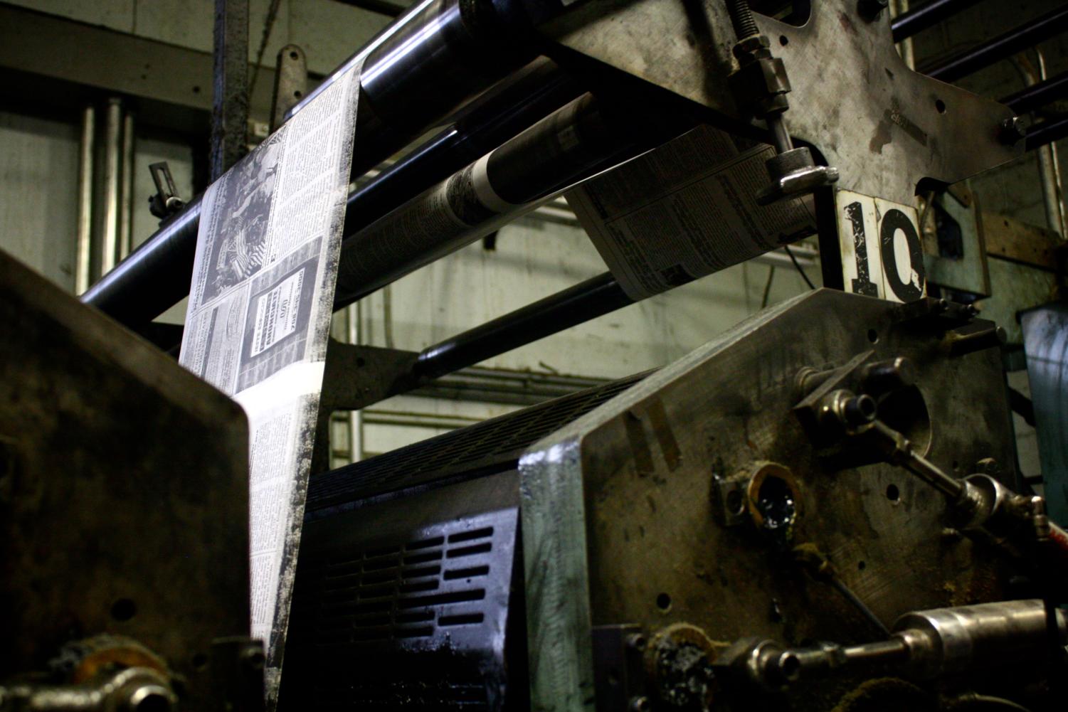 Another view of the printing machinery. After the plate has been inked, it presses against a rubber blanket, transferring the ink to it.