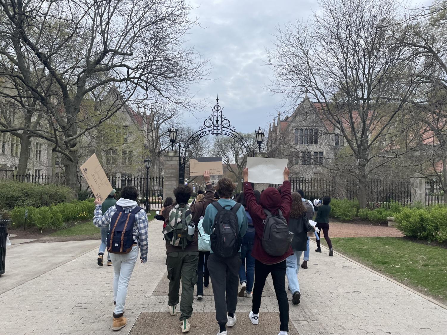 Students held up posters as they marched through Hull Gate at an Environmental Justice Task Force rally on April 29.