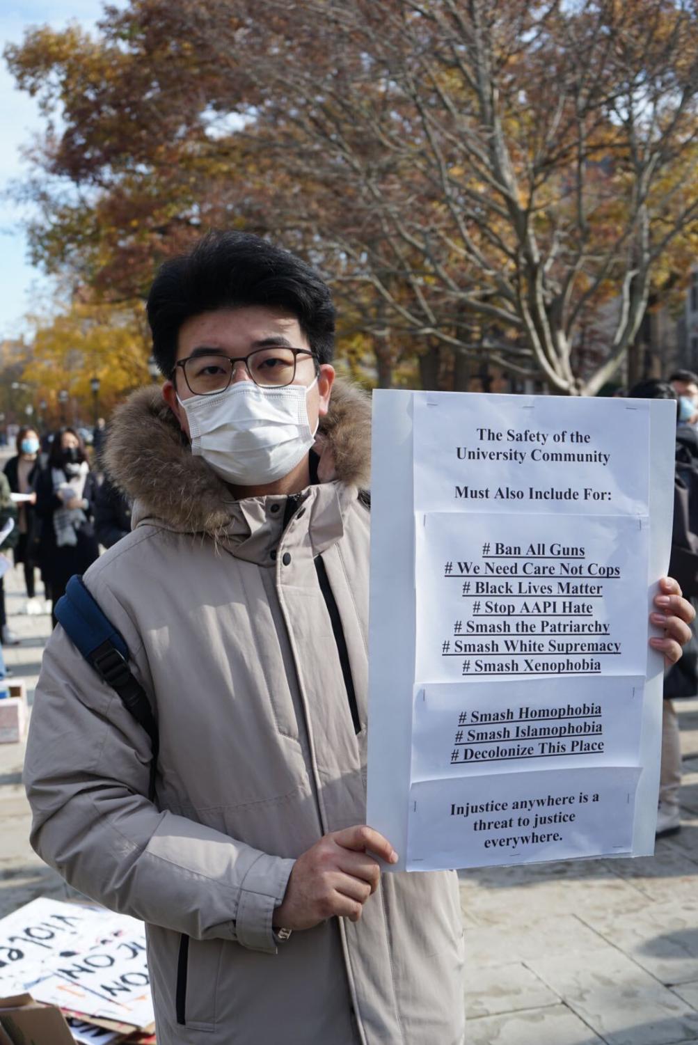 Henry Cheng, a graduate student studying history, made a sign calling for community engagement.