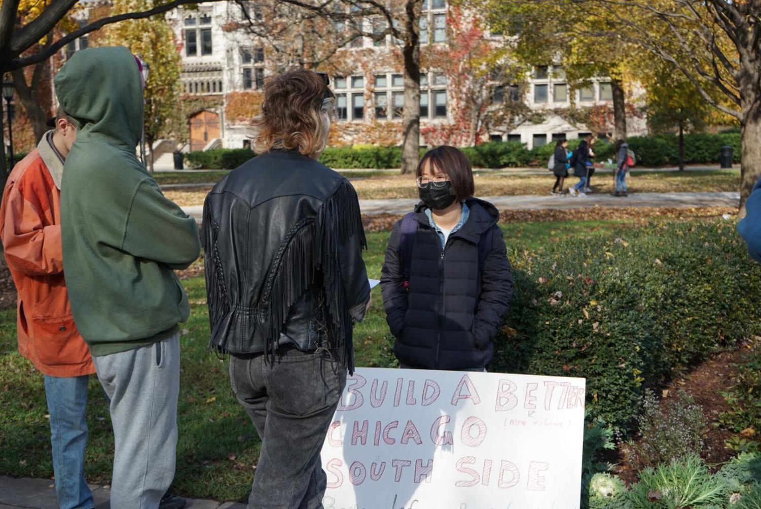 Hang Wu, a Ph.D. student in the Department of Cinema and Media Studies, explained her signs to passersby.