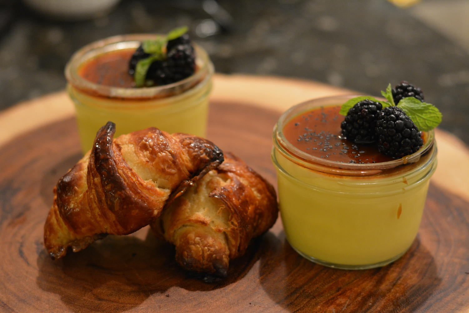 Pot de creme with orange blossom honey, volcanic salt and blackberries, with croissants.