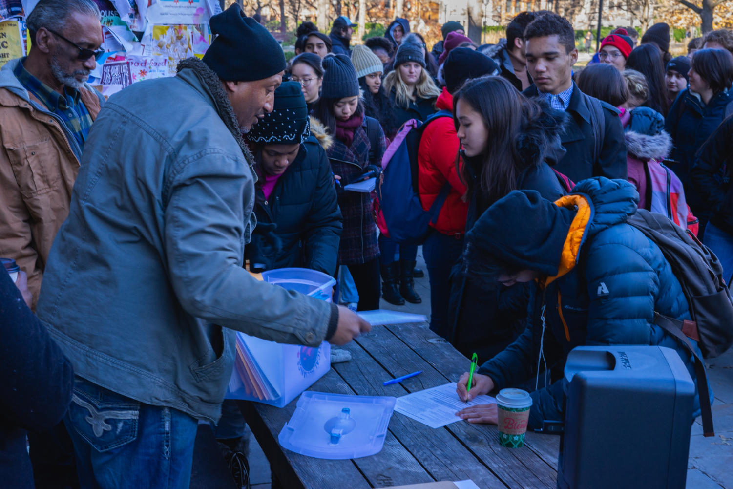 A student fills out a voter registration form before the rally begins.