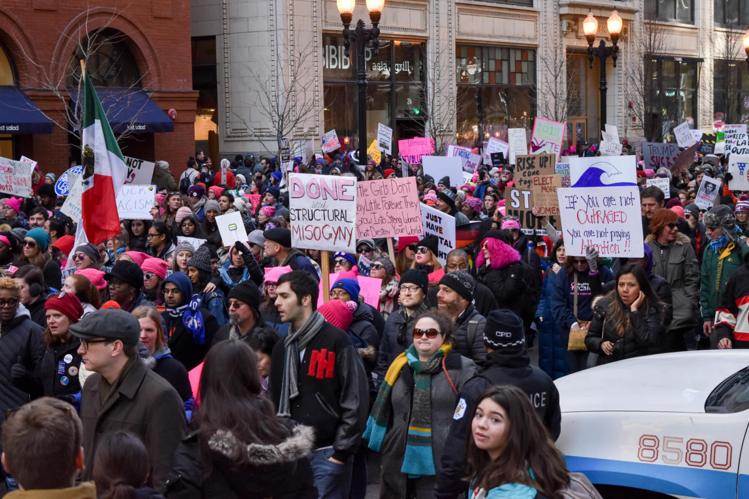 Protesters hold up their signs with pride as they weave their way through the city.