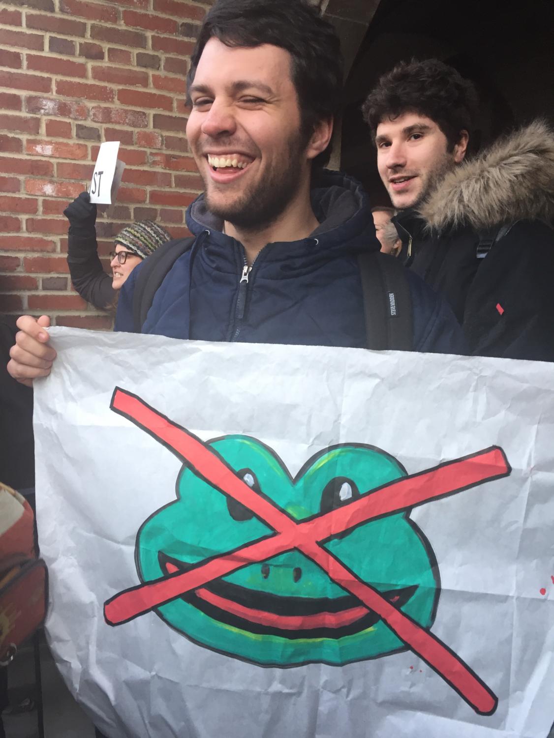 Fourth-year Jake Bittle holds up a sign crossing out white nationalist symbol Pepe the Frog. “The IOP is garbage,” Bittle said.