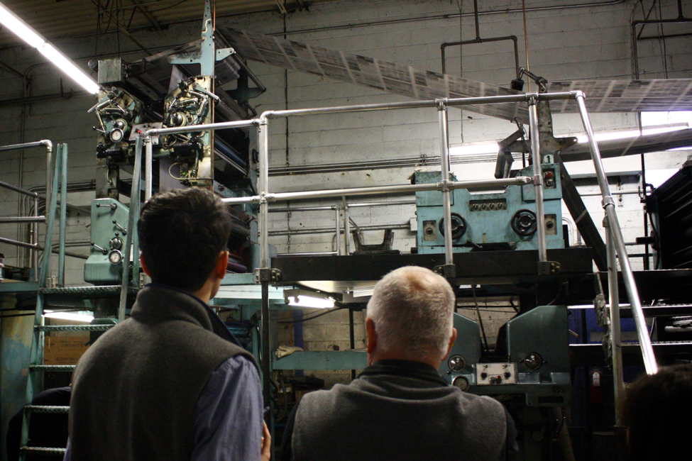 A view of the printing press, which can print up to 22,000 pages per hour. After the ink sets, the pages are cut and folded together.