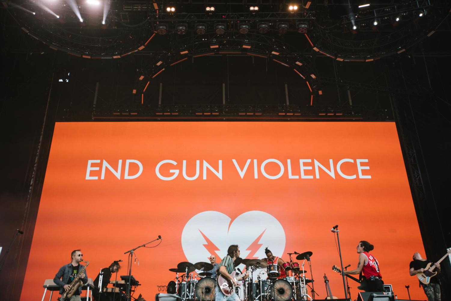 The Revivalists perform at the T-Mobile stage on Sunday in front of a banner that reads 