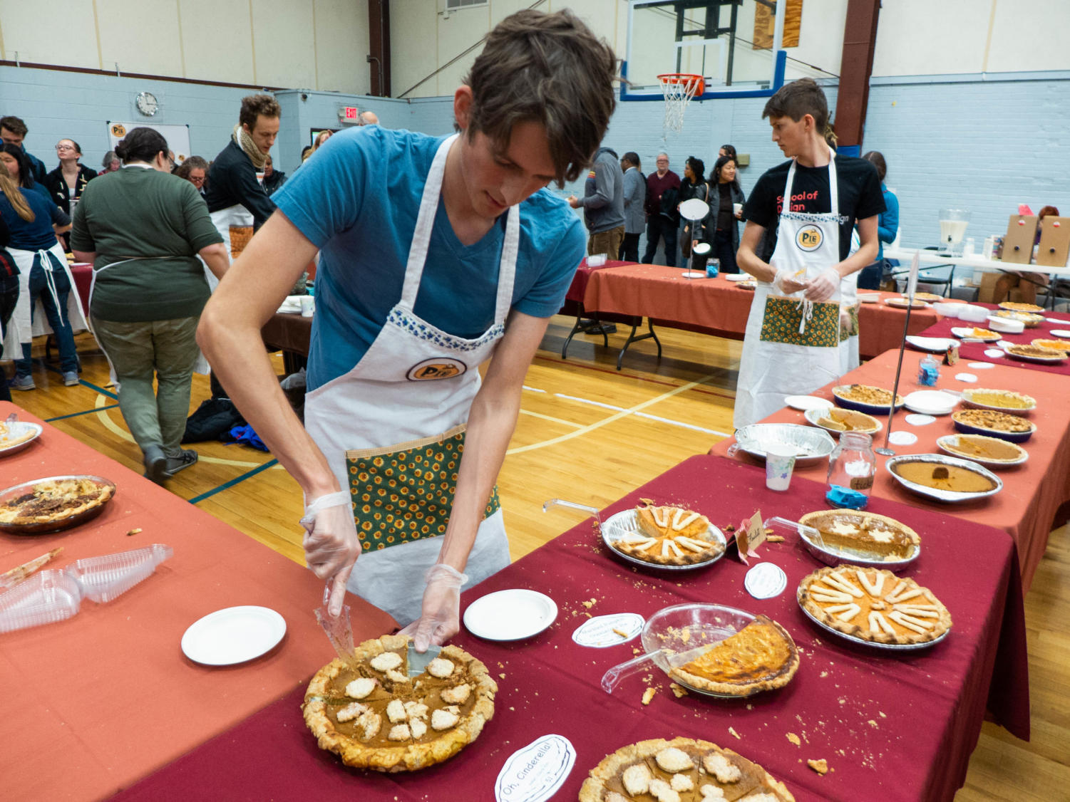 Elvis Wolcott cuts out a slice of a pumpkin pie called “Oh, Cinderella!”