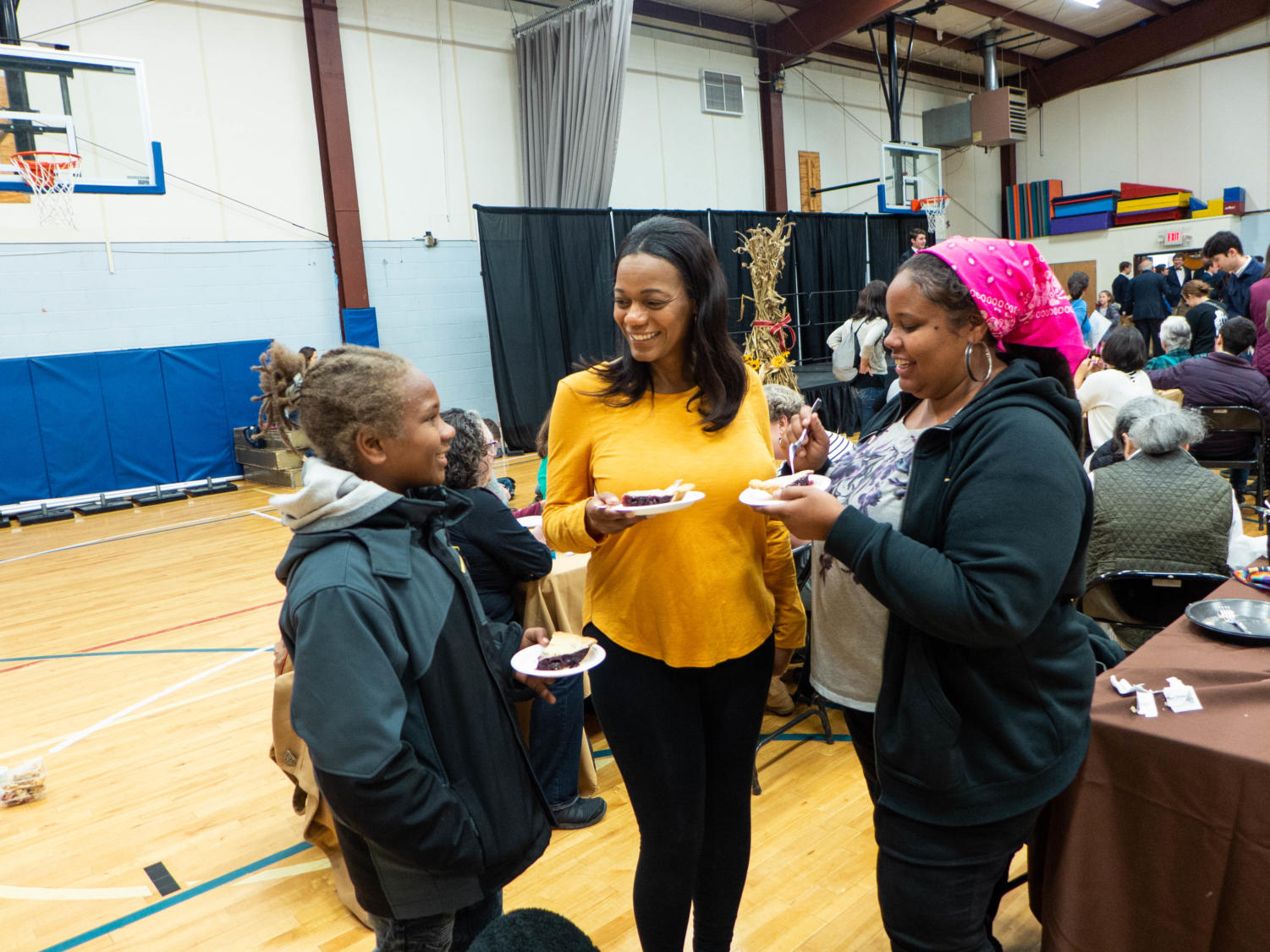 “I’m supporting my best friend in the South Side Pie Challenge,” says Antoinette McCray, right. Gail Davis, who baked a cherry pie, stands center alongside her godson and McCray’s son, Jaylin.