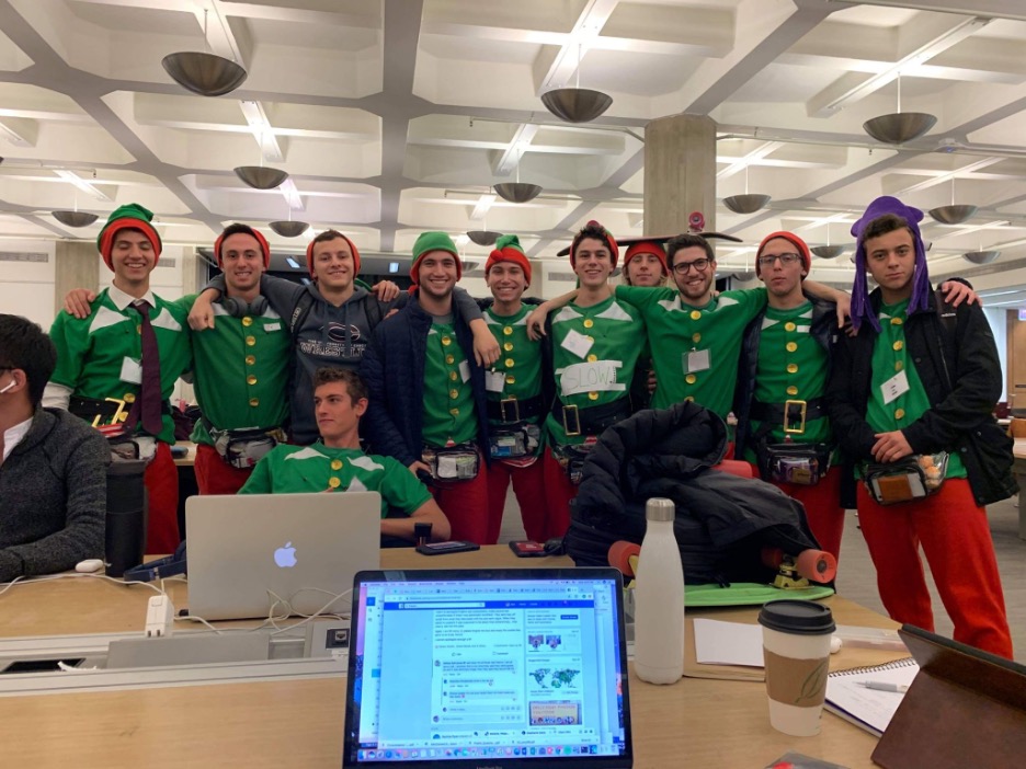 He sent his mother a text of this picture in the fall of his first year: Lewis and his pledge class dressed as elves. In the picture, he is wearing a sign saying “slow.”