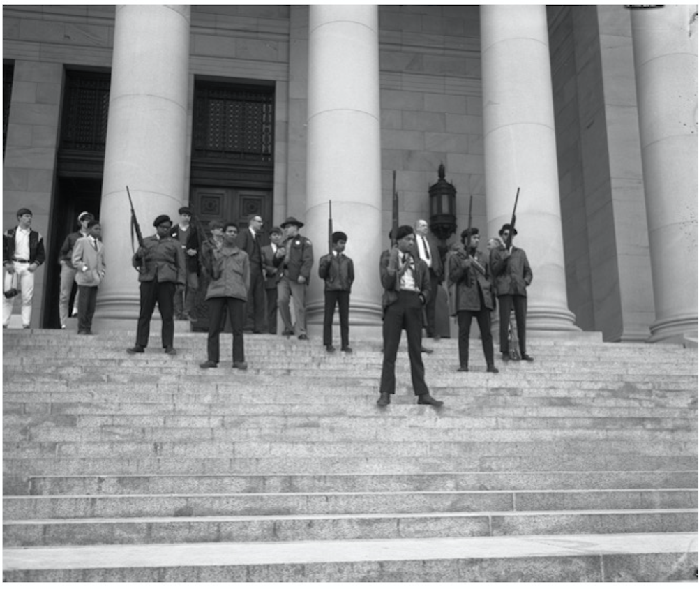 Armed members of the Seattle chapter of the Black Panther Party standing on the state capitol steps protesting a proposed law limiting the ability to carry firearms.